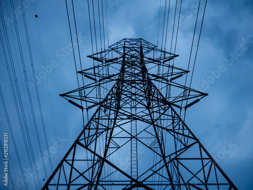 High Voltage Electricity Transmission Tower Pylon Viewed from Below Against Dusk Sky