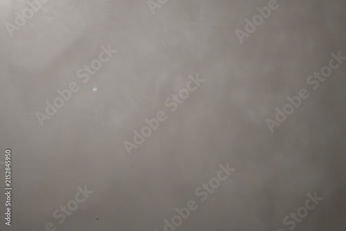 Minimalist close-up of smooth gray surface with subtle shading variations and soft light reflection, emphasizing matte texture and refined simplicity.