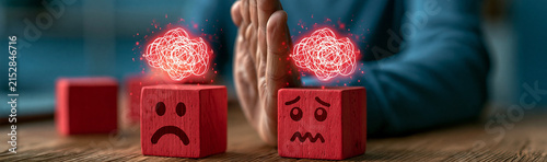 Emotional Disconnect: A close-up shot captures a person's hands separating two red wooden blocks, each with a distressed face.