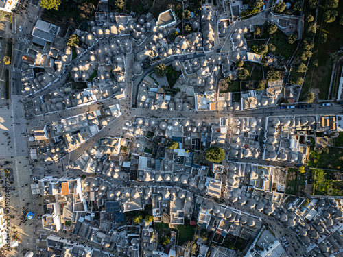 Aerial view of the historic trulli of Alberobello with their characteristic conical limestone roofs and narrow winding streets in the Apulia region, Alberobello, Apulia, Italy.