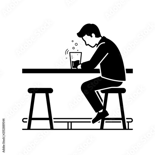 Man sitting alone at a bar drinking a beverage.