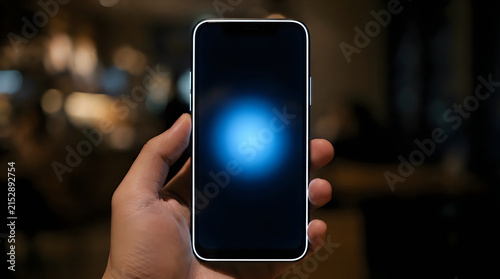 Person holding a smartphone with glowing blue screen at night illustration