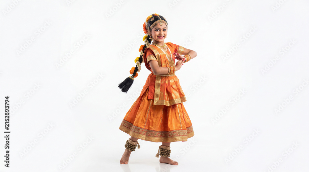 Fototapeta premium Young girl performing traditional indian classical dance in orange costume with floral hair braid cultural celebration