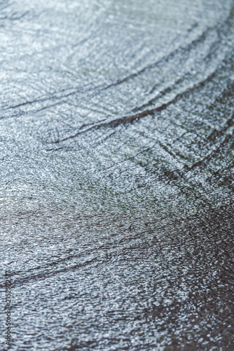 flooded street with streams of rain water. rainy day in the city.
