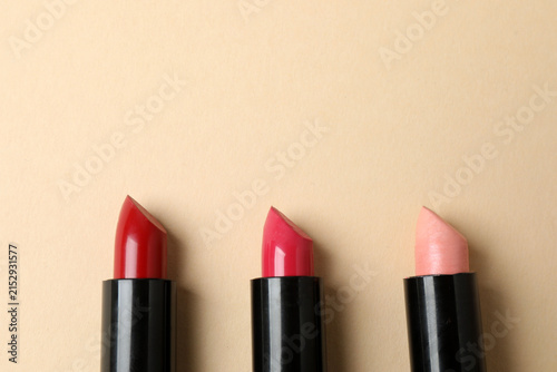 Fotografía Cosmetics and makeup brushes on a beige background, essential beauty and skincare products, flat lay composition