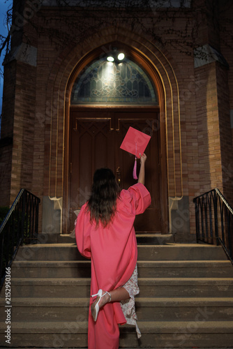 Quadro su tela Celebration of graduation at night with a graduate holding a diploma in front of