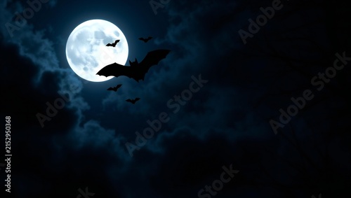 Silhouettes of bats flying in the night sky against a bright full moon