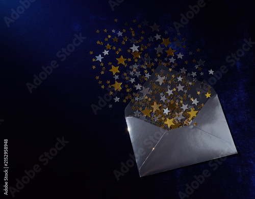 Silver envelope opens, releasing a cascade of sparkling gold and silver stars against a deep blue background, symbolizing wishes, success, and celebration