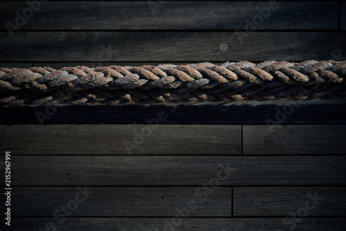 High angle view of a thick braided rope laid horizontally across a wooden ship deck, Gdynia, Pomerania, Poland, Europe