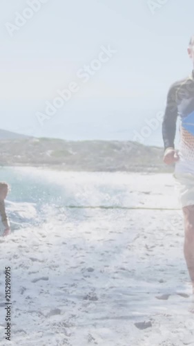 Animation of caucasian surfer sunning over waves and surfing man in background