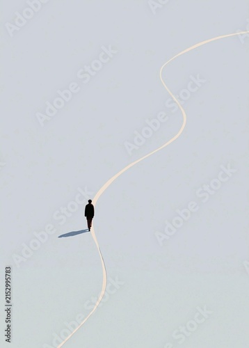 Person walking on a long, straight line that stretches across a light blue sky. the person is wearing a black suit and is walking towards the right side of the image.