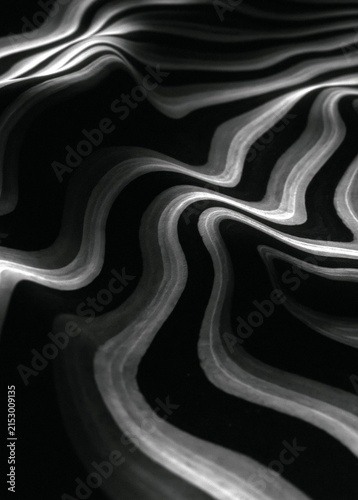Black and white abstract background with wavy lines that create a sense of movement and depth.