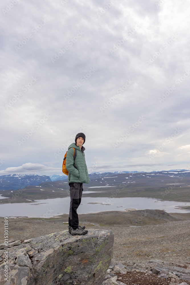 Obraz premium European family with children and pet dog, hiking Halti, the highest peak in Finland, child with pet dog, backpacking, summer, trail