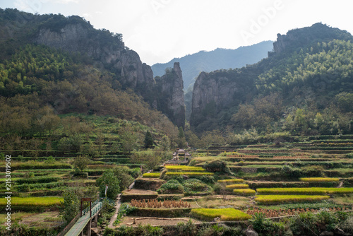 Terraced Fields and Unique Rock Formations in Mountain Valley

