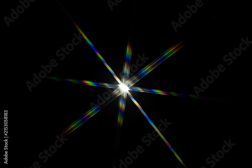 a bright starburst effect with colorful lens flares, often created by photographing a strong light source directly