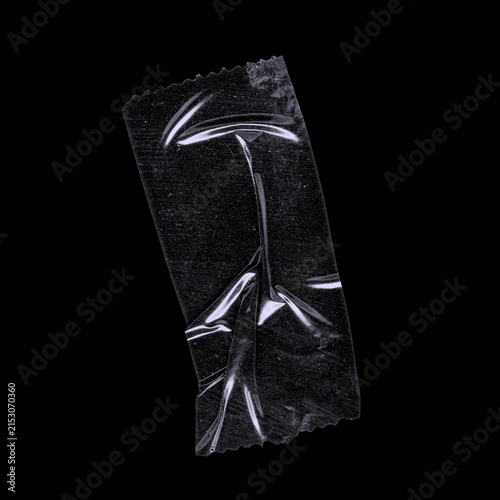 Vertical black duct tape strip with branching star-like shiny folds on black background, realistic adhesive tape isolated