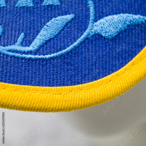 Obraz na płótnie Blue baseball cap elements showing the visor and rear section decorated with a traditional Ukrainian pattern