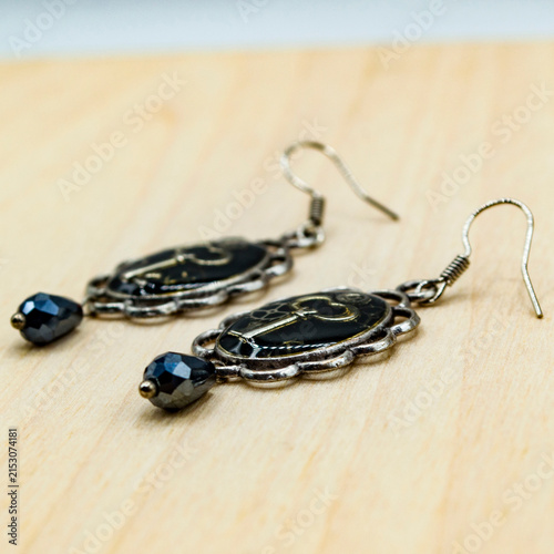 Steampunk earrings featuring a vintage key and mechanical gears with an industrial Victorian aesthetic. Ideal as a mockup for designers, jewelry concepts, fashion projects and product presentations