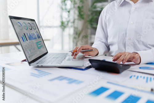 Business woman analysis summary graph reports of business operating expenses and work data about the company's financial statements.