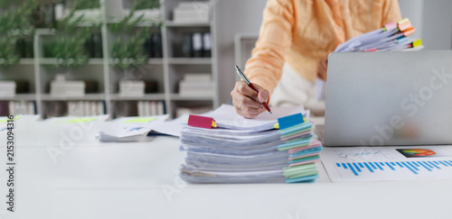 Businesswoman organizing financial documents and reports on office desk Financial Documents and Files in Office