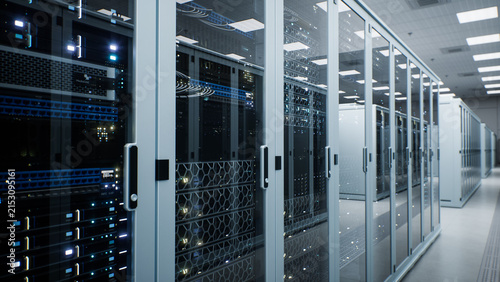White Modern Data Center Server Room. Close up Along a Receding Line of Locked Enclosures With Transparent Doors Exposing Power Distribution Units, Cable Harnesses and Vent Panels Cooling Ai Hardware.