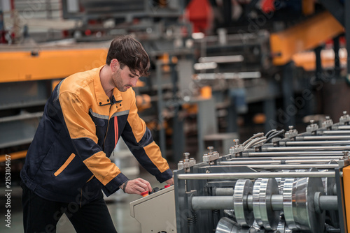 Technician Operating Machinery in Industrial Steel Manufacturing Plant
