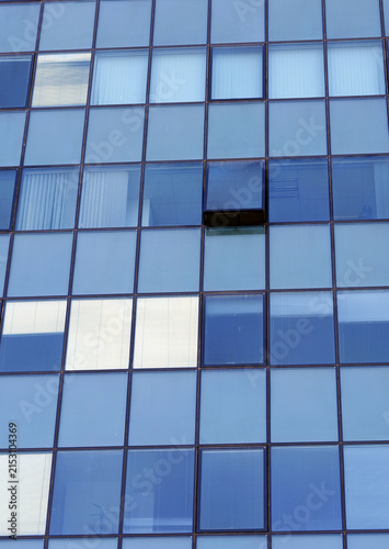 Modern office building facade showing blue glass windows