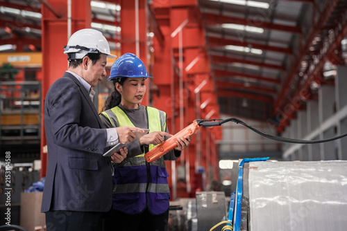 Industrial Technicians Collaborate in Modern Steel Factory Setting