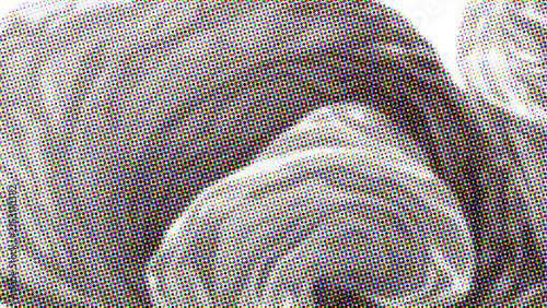 Abstract close up of dark gray fabric folds with halftone print texture effect.