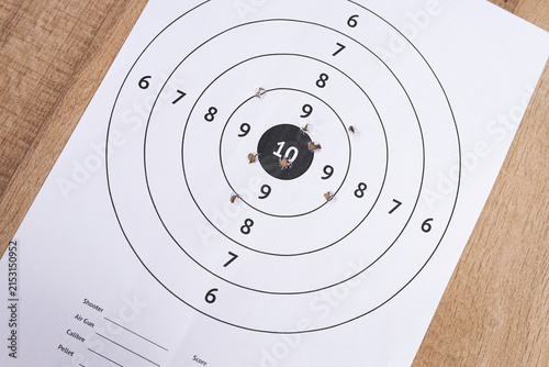 High Angle of Paper Shooting Target with Holes Near Center Bullseye