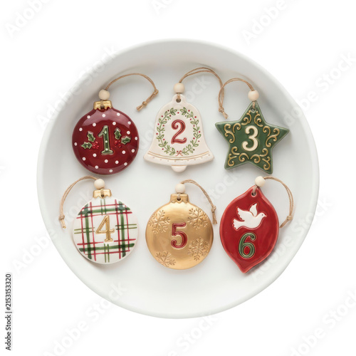 Christmas advent calendar ornaments in a white bowl