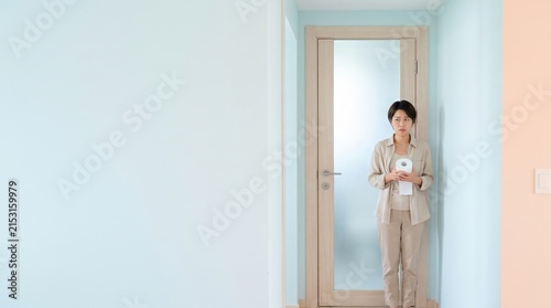 Woman holding toilet paper, looking anxious and uncomfortable, possibly due to hemorrhoids or gastrointestinal issues.