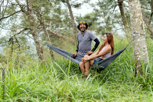 Canvastavla Asian couple relaxing together in a hammock surrounded by lush tropical nature