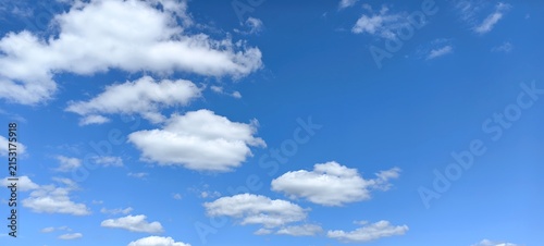 Blue sky with white clouds, natural background.