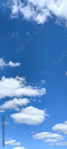 Blue sky with white clouds, natural background.