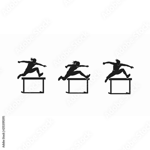 Female athletes jumping over hurdles during track and field race