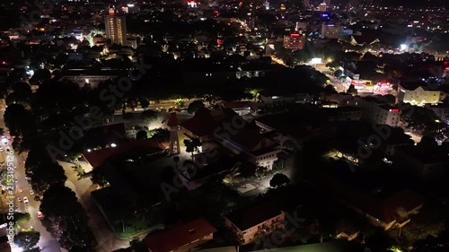 Night Hyperlapse Drone Orbit Around the Bishop's Palace of Buon Ma Thuot Diocese, Illuminated Catholic Religious Architecture and Landmark in Buon Ma Thuot, Dak Lak, Vietnam