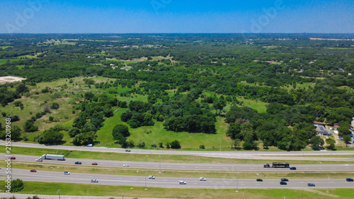 Картината върху платно Grassy medians separate main highway lanes from service routes along Interstate 35W in North Texas