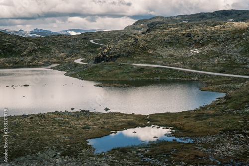 Obraz na plátně Mirror-like reflection of summer clouds on a high-altitude tarn along the Sognef