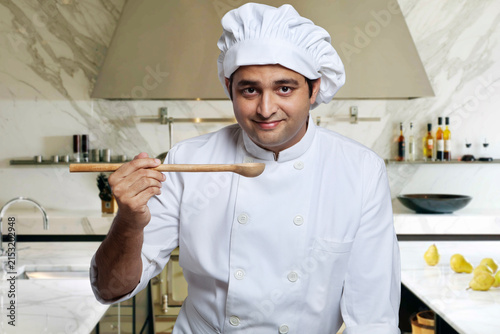 Portrait of a chef with a wooden spoon 