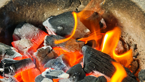 The fire is burning in the stove.