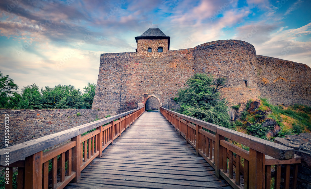 Fototapeta premium Spectacular summer view of Helfstyn castle - 16th-century, fortified hilltop castle complex, with towers, bastions and courtyards with wooden bridge, Tyn nad Becvou village, Czech Republic.