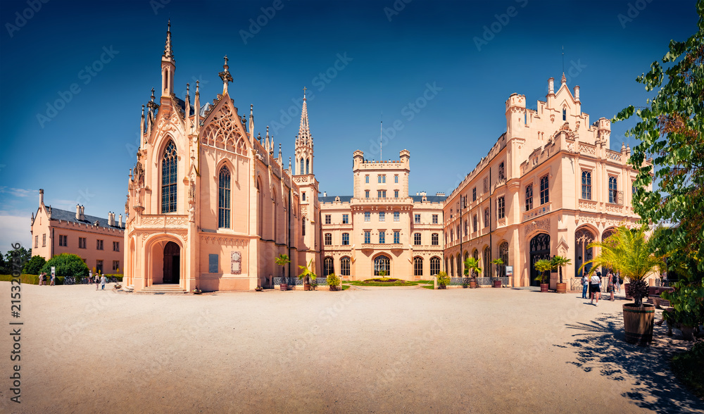 Obraz premium Fabulous afternoon view of Lednice castle, 1800s palace built on a Renaissance chateau and Gothic fort, with a riding hall and formal gardens. Sunny summer cityscape of Lednice town, Czech Republic;.