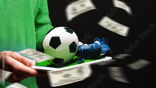Cuadro en lienzo Sport betting on soccer with cash flying and soccer items on a tray