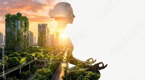 Double exposure of meditating woman and green city skyline.