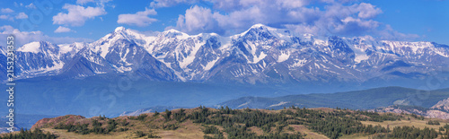 Panoramic mountain view, snow-capped mountain peaks, sunny day, summer travels