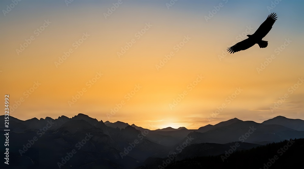 Naklejka premium Silhouette of soaring bird flying over mountain range at golden sunset, ideal for nature, wildlife, and inspirational themes.