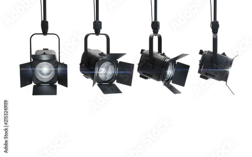 Four professional stage spotlights hanging from a track isolated on transparent background