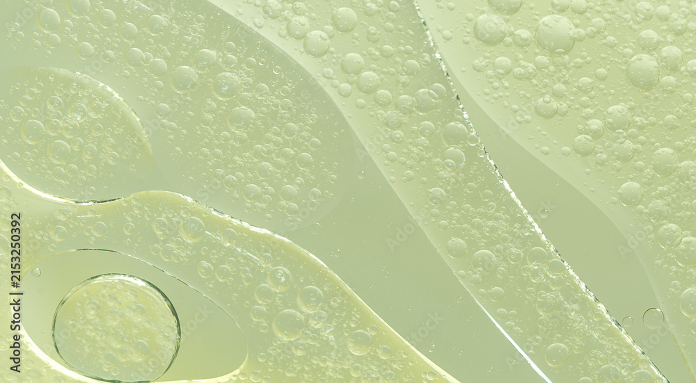 Fototapeta premium Abstract Green water bubbles essential oil beauty collagen Serum Repair cell background.