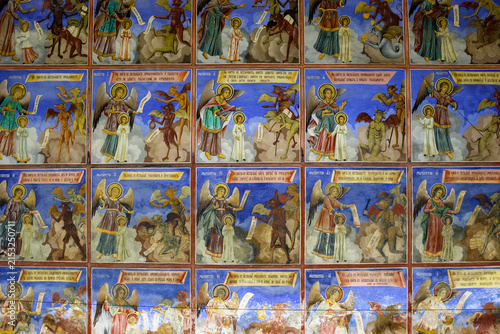 A fresco depicting angels and demons in a religious scene, likely from a church or monastery, with inscriptions in Cyrillic script.